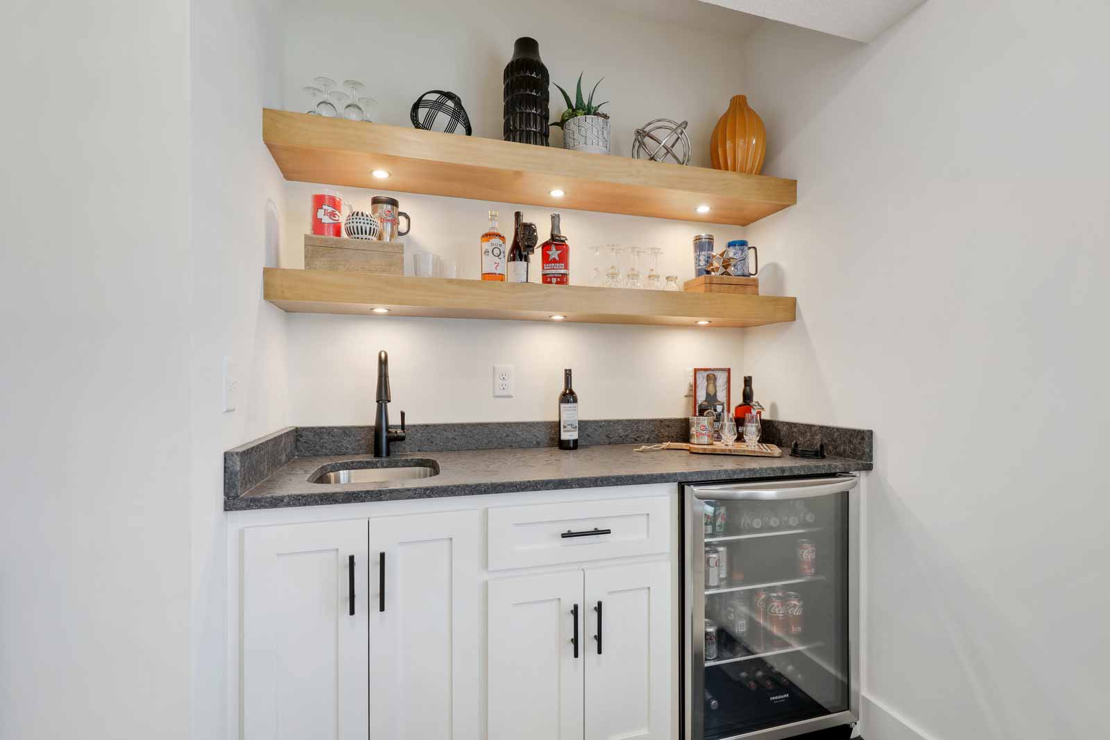 Wet bar with a wine fridge in a Kenneth Estates home