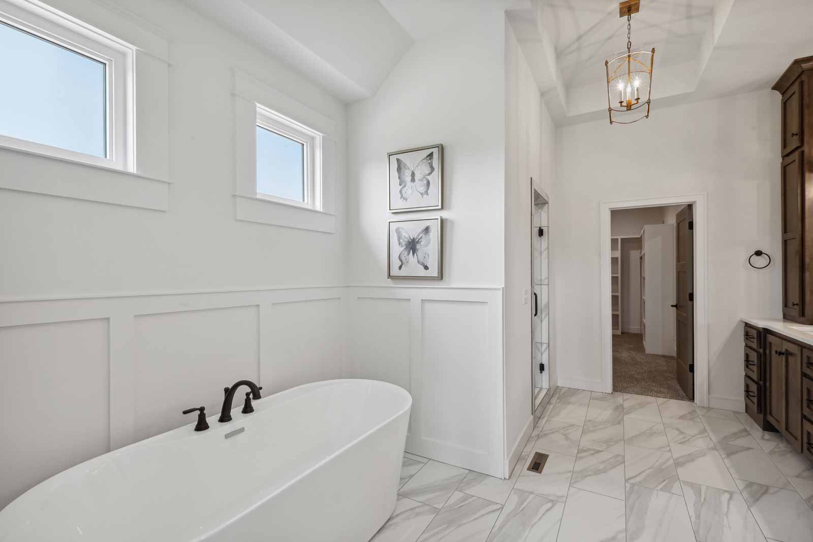 Master bathroom with marble tile and tub