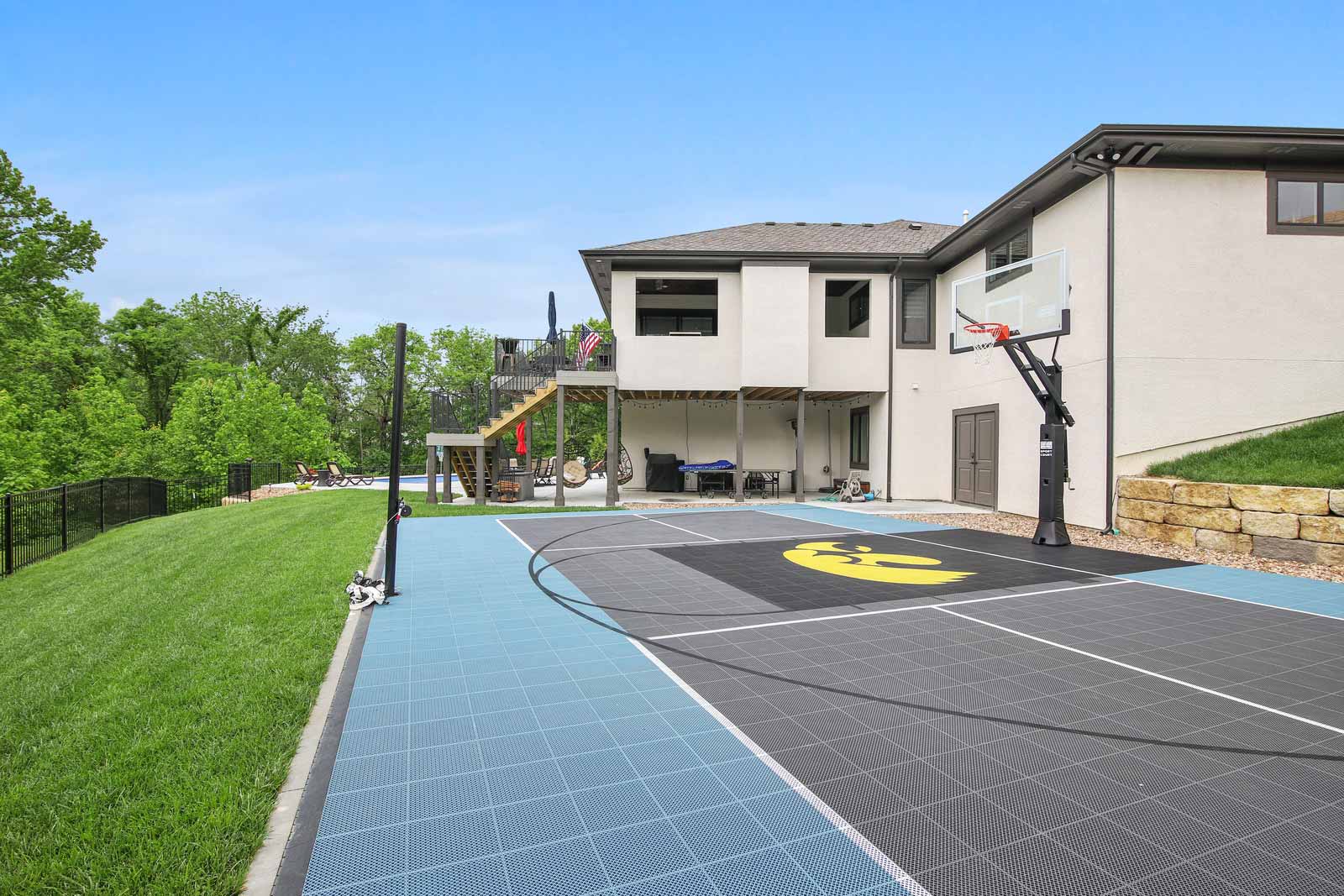 Backyard of Kenneth Estates home with basketball court