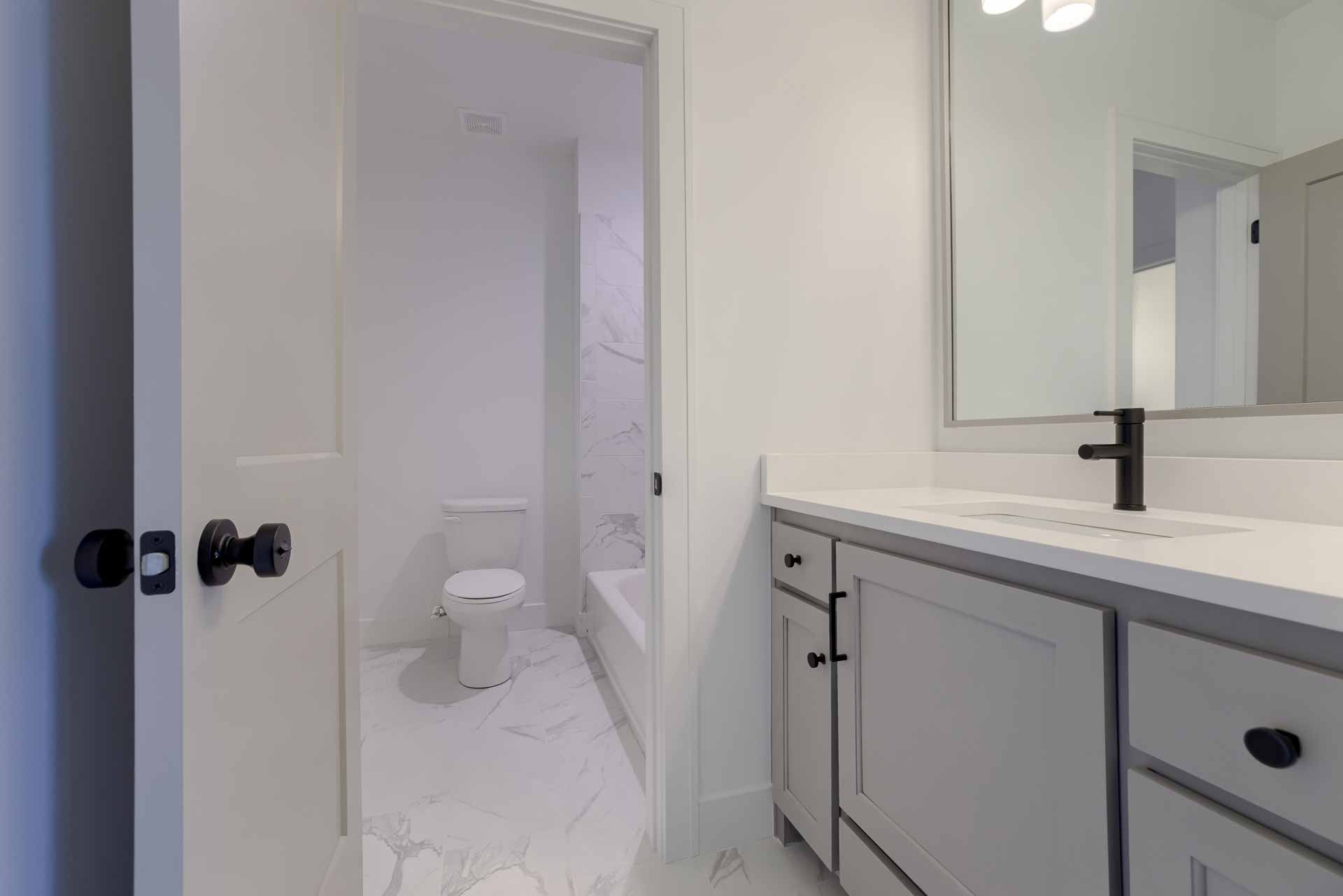 Bathroom with white marble flooring and tiling