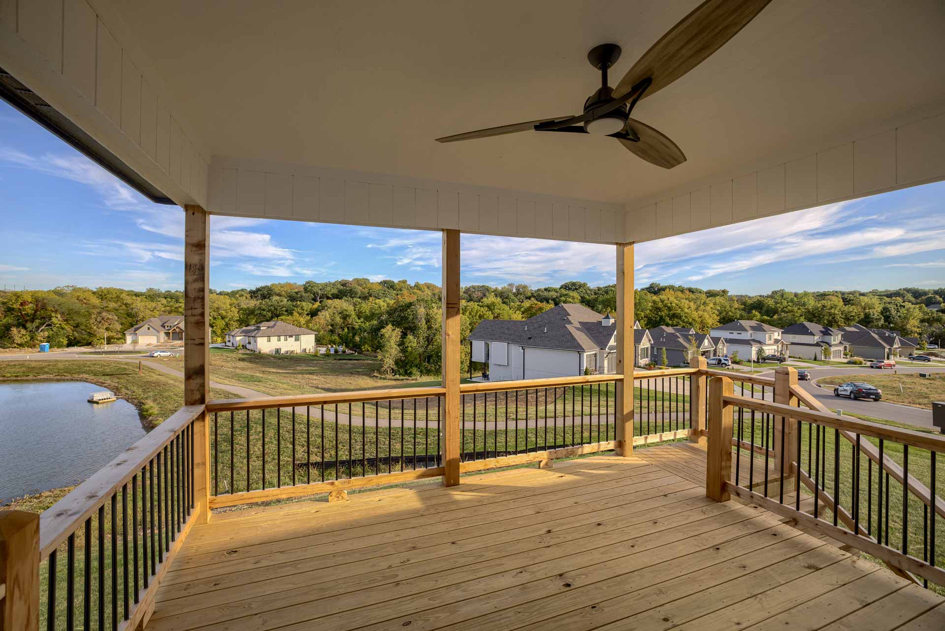 Deck with fan connecting to patio in Kenneth Estates home
